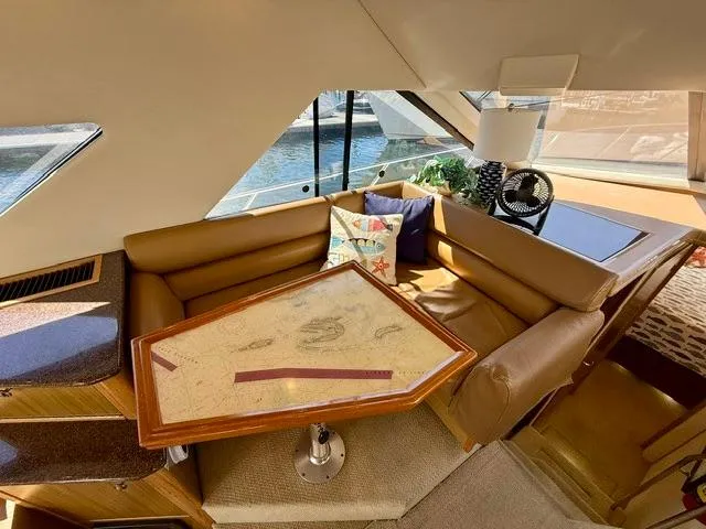 Slide: The Image of Interior of 2002 Bayliner 3988 yacht with cozy seating and nautical-themed decor. - 38