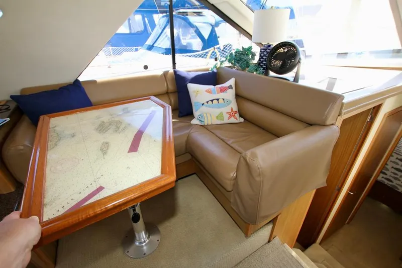 Slide: The Image of Interior of 2002 Bayliner 3988 yacht with leather seating and nautical-themed decor. - 48
