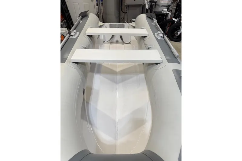 Slide: The Image of Inflatable dinghy interior with white benches, associated with 2002 Bayliner 3988 Motoryacht. - 83
