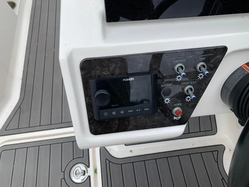 Slide: The Image of Control panel of a 2020 Sea Ray SPX 190 Outboard boat with audio system and switches. - 3