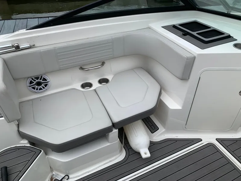 Slide: The Image of 2020 Sea Ray SPX 190 Outboard boat interior with cushioned seating and cup holders. - 4