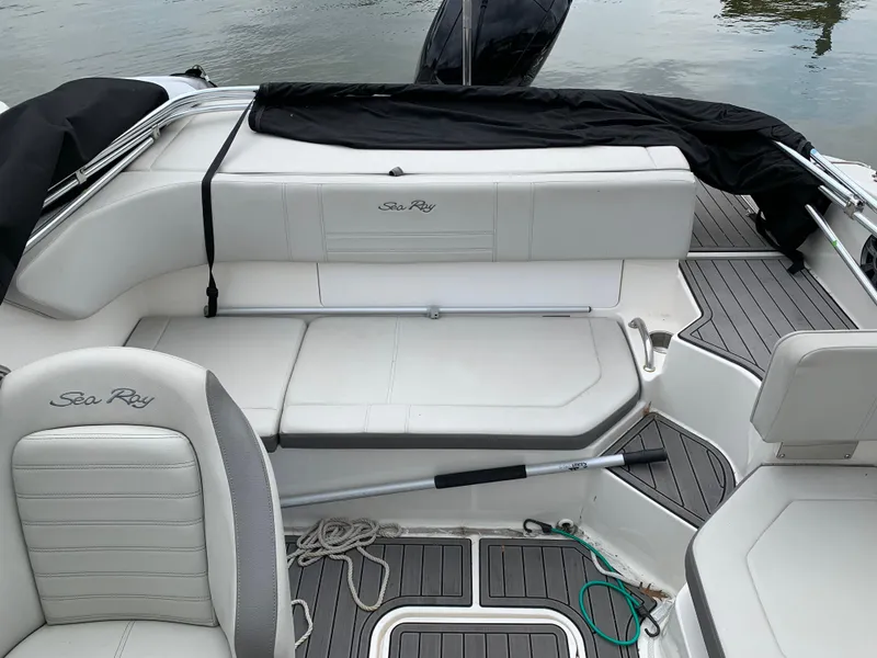 Slide: The Image of 2020 Sea Ray SPX 190 Outboard boat interior with white seating and gray flooring. - 5