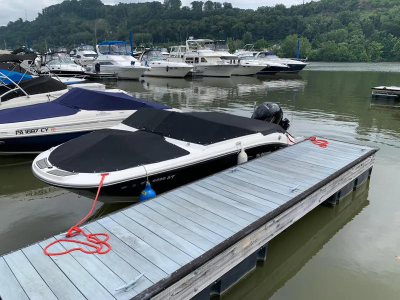 Slide: The Image of 2020 Sea Ray SPX 190 Outboard boat docked at a marina with other vessels. - 7