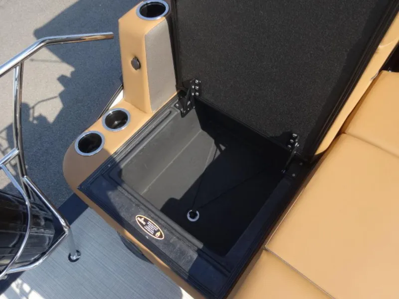 Slide: The Image of Open storage compartment on 2025 Harris Cruiser 250 LUX boat with cup holders. - 13