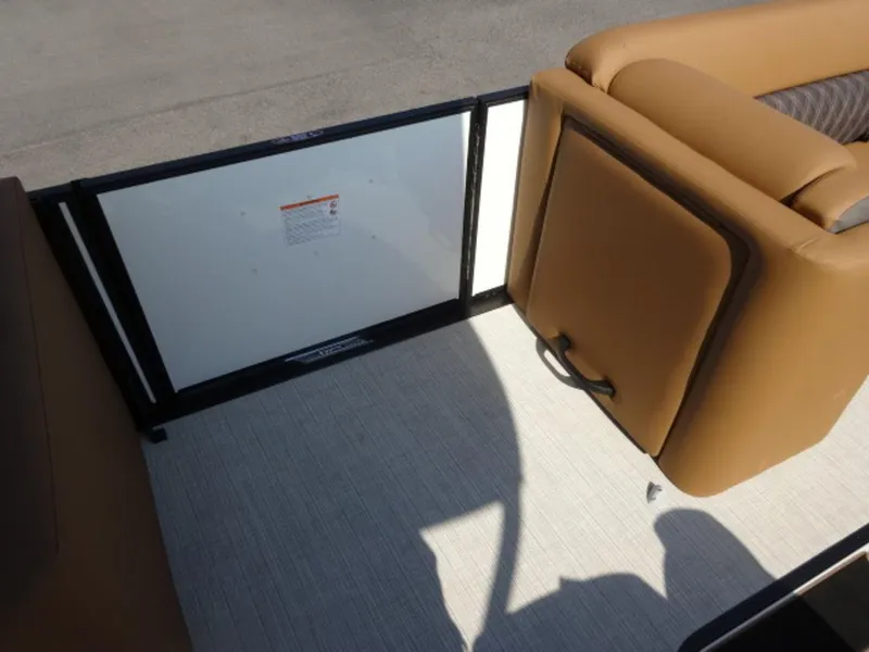 Slide: The Image of 2025 Harris Cruiser 250 LUX interior with tan seating and safety gate. - 7