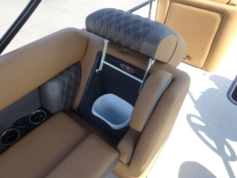 Slide: The Image of 2025 Harris Cruiser 250 LUX boat interior with tan seating and built-in storage. - 8