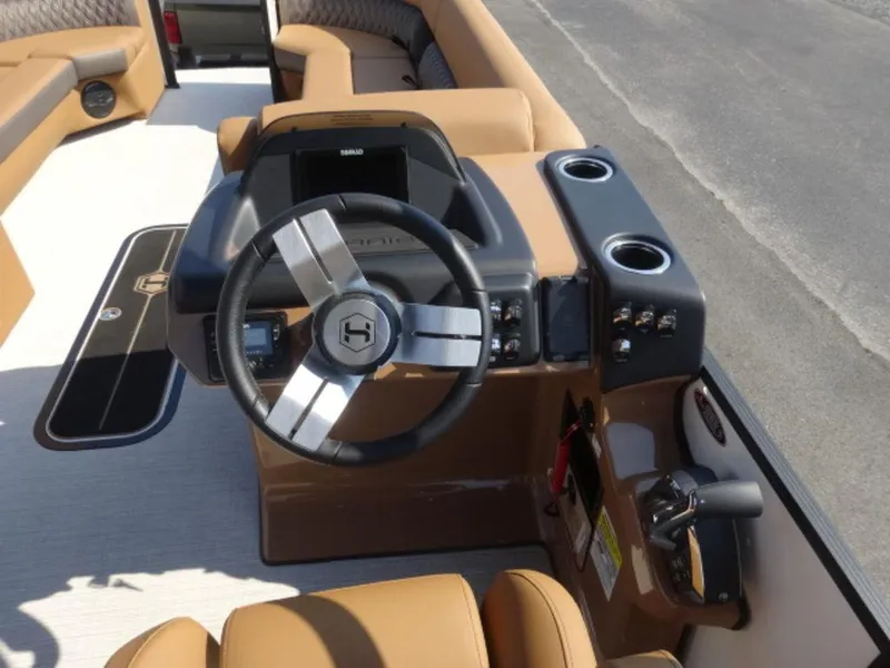 Slide: The Image of 2025 Harris Cruiser 250 LUX boat dashboard with steering wheel and controls. - 9