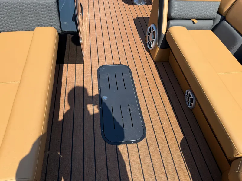 Slide: The Image of 2026 Bentley Pontoons Elite 253 QSB interior with tan seating and wood-style flooring. - 15
