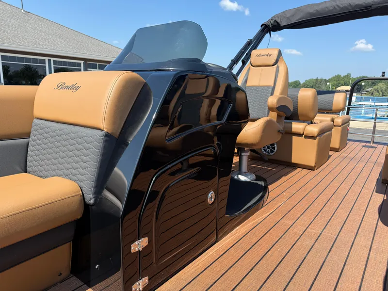 Slide: The Image of 2026 Bentley Pontoons Elite 253 QSB interior with luxurious tan and black seating. - 17