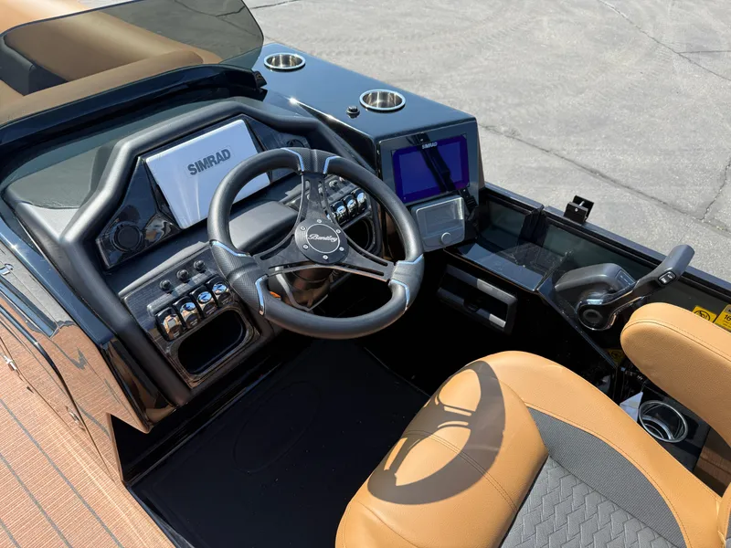 Slide: The Image of 2026 Bentley Pontoons Elite 253 QSB dashboard with steering wheel and navigation system. - 21