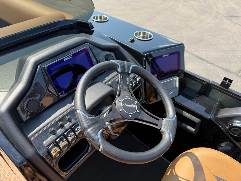 Slide: The Image of 2026 Bentley Pontoons Elite 253 QSB dashboard with steering wheel and Simrad displays. - 22