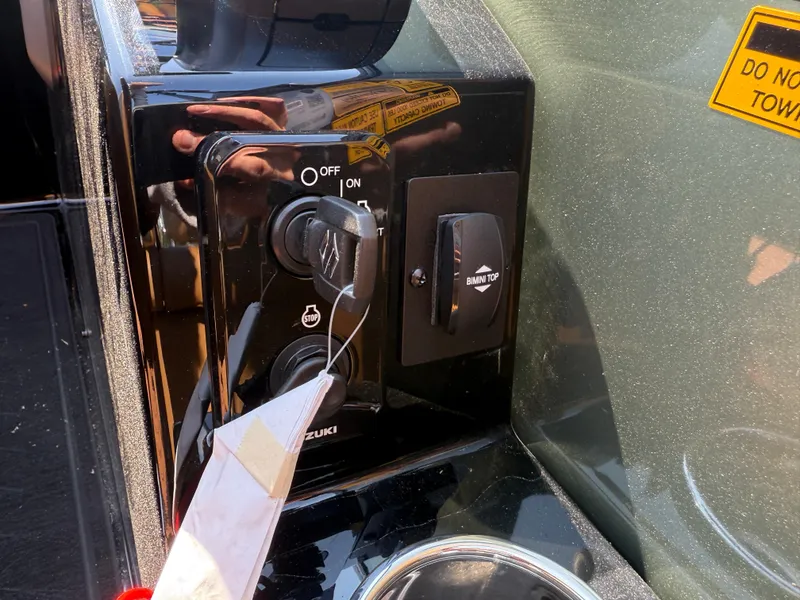 Slide: The Image of Control panel of 2026 Bentley Pontoons Elite 253 QSB with ignition and Bimini top switch. - 26