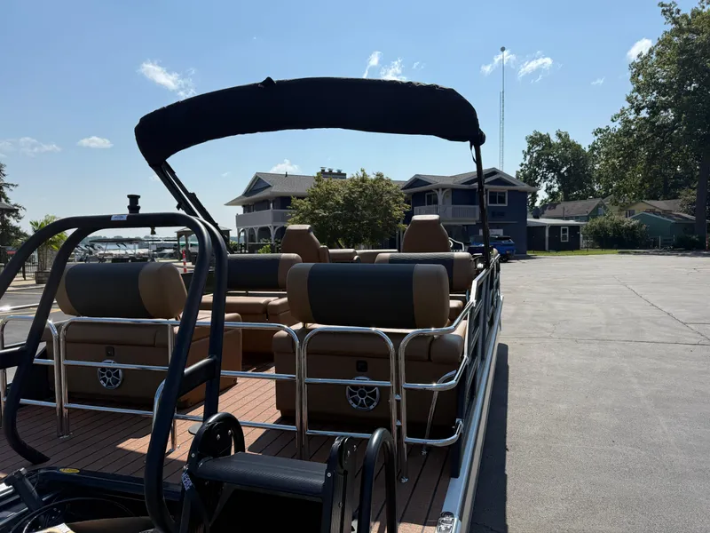 Slide: The Image of 2026 Bentley Pontoons Elite 253 QSB docked, showcasing luxurious seating and sleek design. - 3