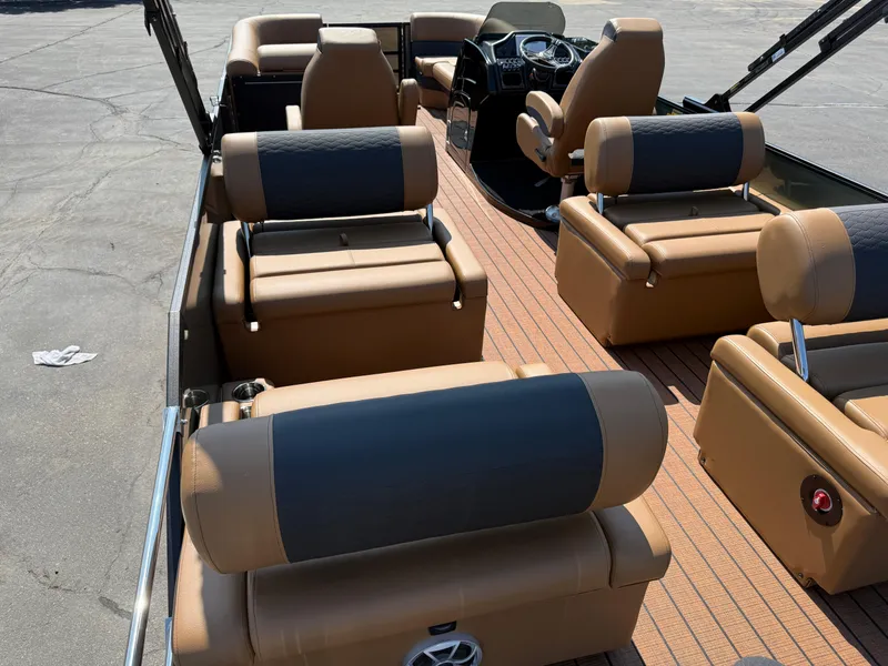 Slide: The Image of 2026 Bentley Pontoons Elite 253 QSB interior with luxurious tan seating and modern dashboard. - 32