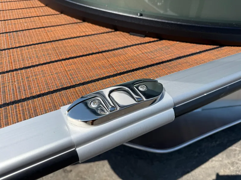 Slide: The Image of 2026 Bentley Pontoons Elite 253 QSB deck detail with sleek chrome cleat. - 38