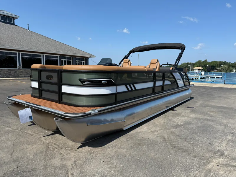 Slide: The Image of 2026 Bentley Pontoons Elite 253 QSB pontoon boat parked near a marina under clear skies. - 4