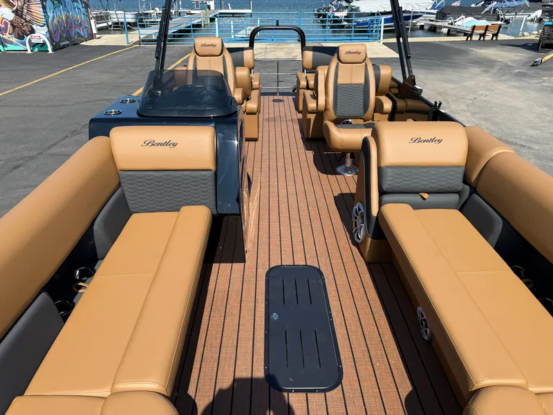 Slide: The Image of 2026 Bentley Pontoons Elite 253 QSB with luxurious tan seating and sleek design. - 9
