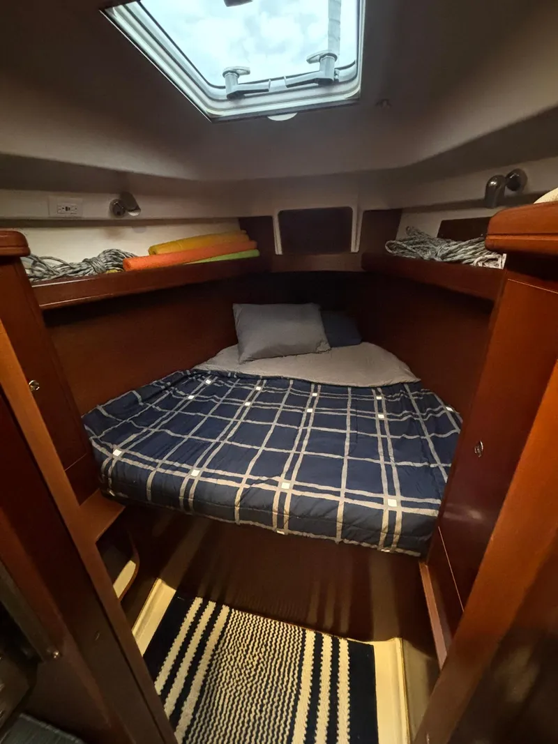 Slide: The Image of Cozy cabin interior of 2006 Beneteau 343 Sloop with plaid bedding and skylight. - 13