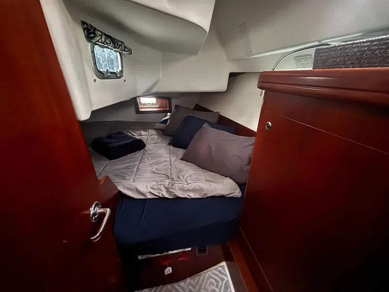 Slide: The Image of Cozy cabin interior of 2006 Beneteau 343 Sloop with bed and wooden cabinetry. - 16
