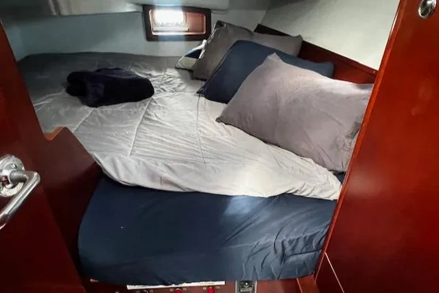 Slide: The Image of Cozy cabin interior of 2006 Beneteau 343 Sloop with neatly arranged bedding. - 17