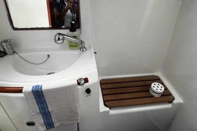 Slide: The Image of Bathroom interior of 2006 Beneteau 343 Sloop with sink and wooden shower seat. - 18