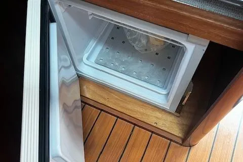 Slide: The Image of Open fridge inside 2006 Beneteau 343 Sloop, wooden flooring visible. - 25