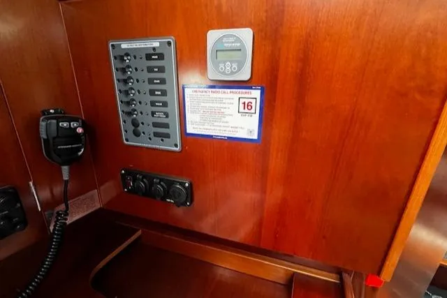 Slide: The Image of Control panel on 2006 Beneteau 343 Sloop with radio and switches on wooden interior. - 27
