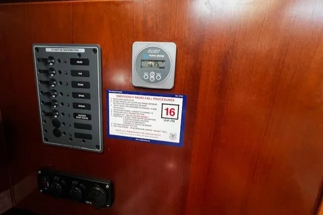 Slide: The Image of Control panel on 2006 Beneteau 343 Sloop with emergency radio call procedures. - 28
