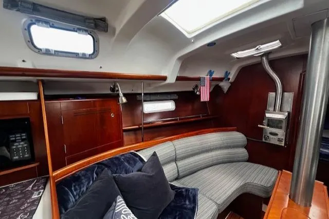 Slide: The Image of Interior of 2006 Beneteau 343 Sloop, featuring cozy seating and elegant wood finishes. - 3