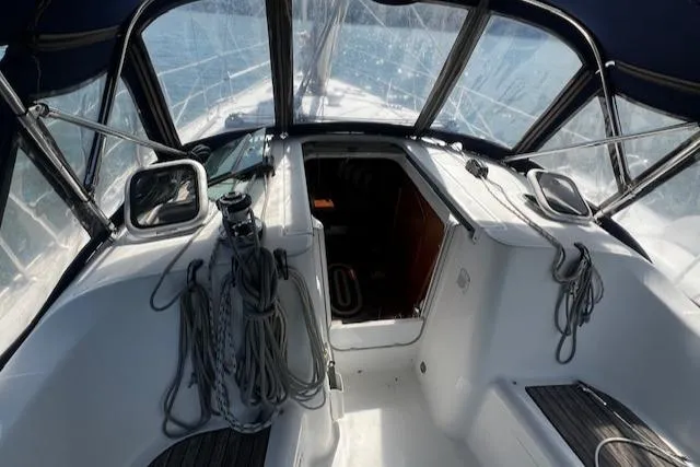 Slide: The Image of 2006 Beneteau 343 Sloop cockpit with ropes and canopy, showcasing sailing equipment. - 40