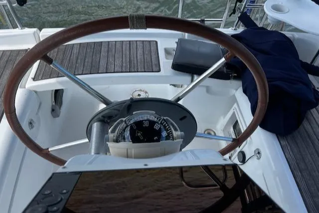 Slide: The Image of Steering wheel of a 2006 Beneteau 343 Sloop with compass and navigation equipment. - 43