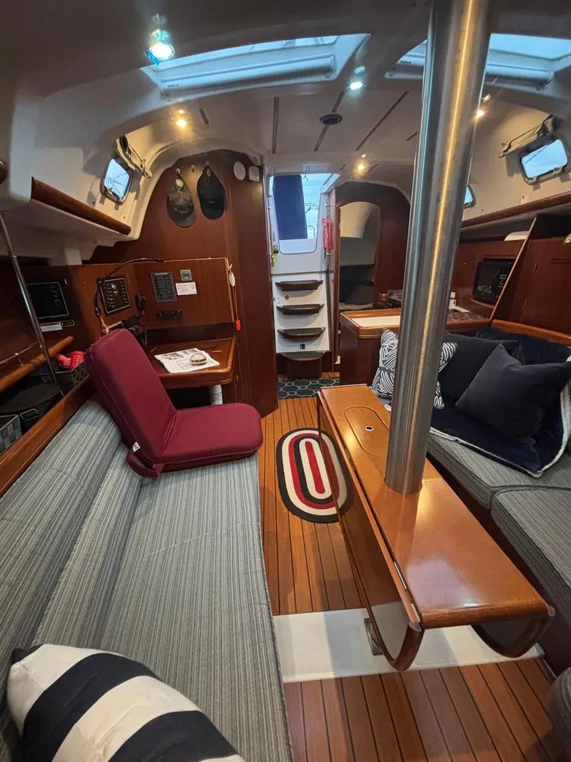Slide: The Image of Interior of 2006 Beneteau 343 Sloop, featuring cozy seating and wooden finishes. - 5