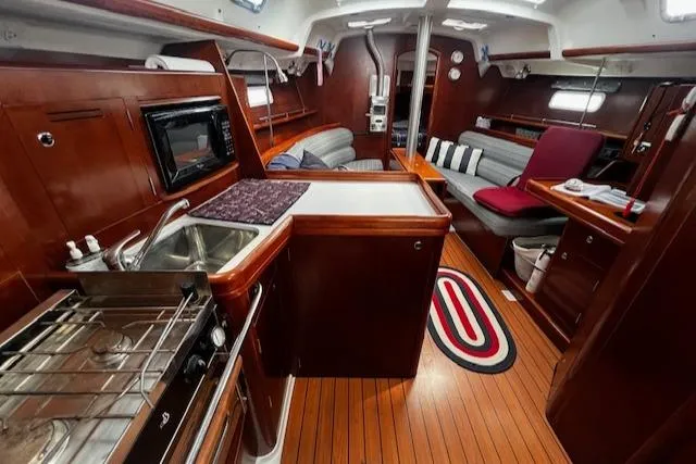 Slide: The Image of Interior of 2006 Beneteau 343 Sloop, featuring a cozy kitchen and seating area. - 6