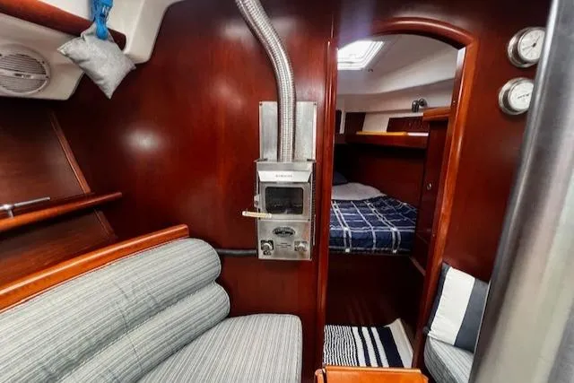 Slide: The Image of Interior of 2006 Beneteau 343 Sloop, featuring cozy seating and a compact cabin. - 7