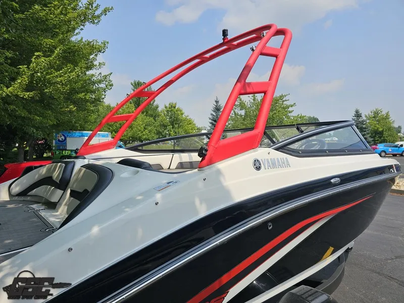 Slide: The Image of 2019 Yamaha AR195 boat with red wakeboard tower, parked outdoors. - 10