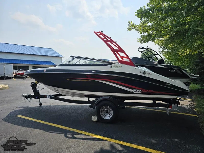 Slide: The Image of 2019 Yamaha AR195 boat on trailer, parked outdoors near a building. - 22