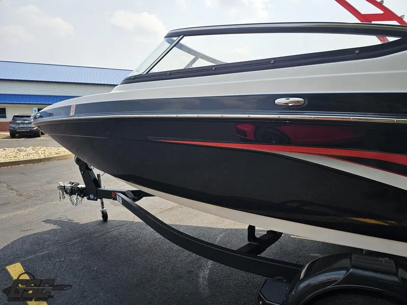 Slide: The Image of 2019 Yamaha AR195 boat on trailer, black and red design, parked outdoors. - 23