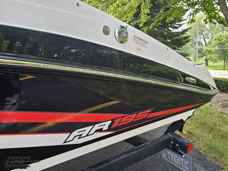 Slide: The Image of 2019 Yamaha AR195 boat on trailer, featuring sleek black and red design. - 24