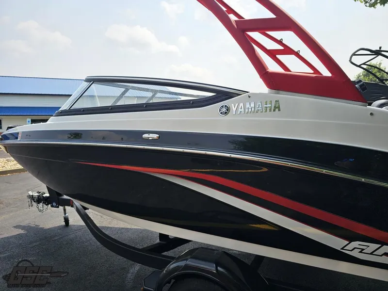 Slide: The Image of 2019 Yamaha AR195 boat with sleek black and red design on trailer. - 25