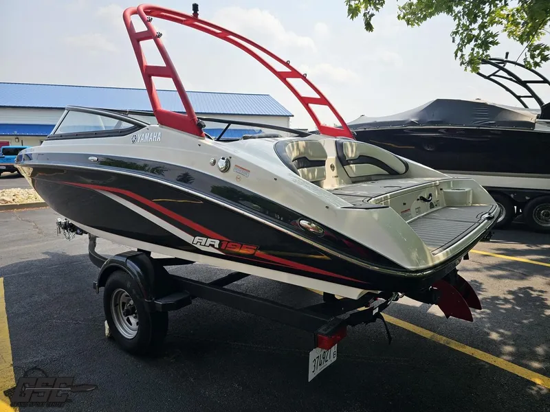 Slide: The Image of 2019 Yamaha AR195 boat with red tower, parked on trailer. - 27