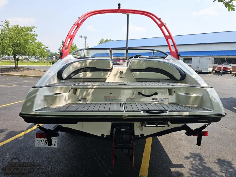 Slide: The Image of 2019 Yamaha AR195 boat with red wakeboard tower, parked outdoors. - 29
