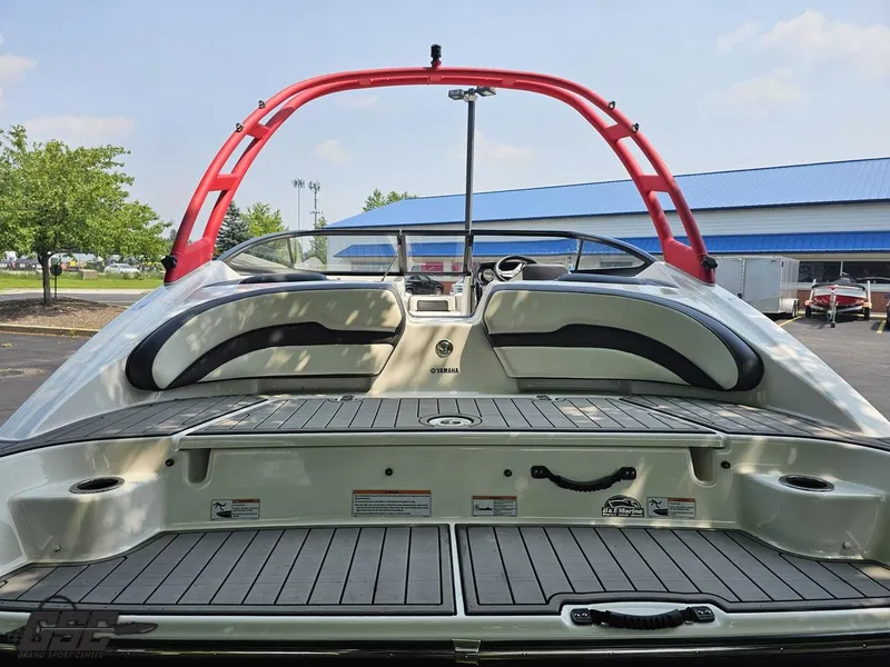 Slide: The Image of 2019 Yamaha AR195 boat with red wakeboard tower and spacious rear deck. - 31