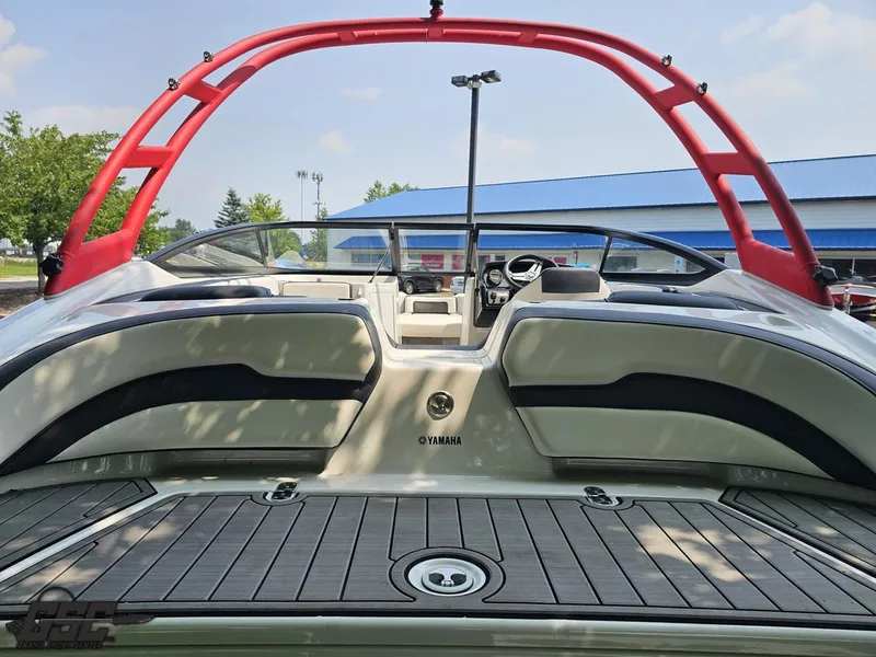 Slide: The Image of 2019 Yamaha AR195 boat interior with red wakeboard tower and spacious seating. - 35