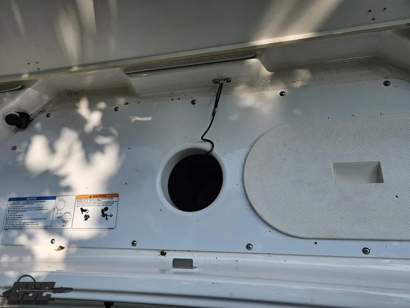 Slide: The Image of 2019 Yamaha AR195 boat interior compartment with open hatch and visible warning labels. - 36