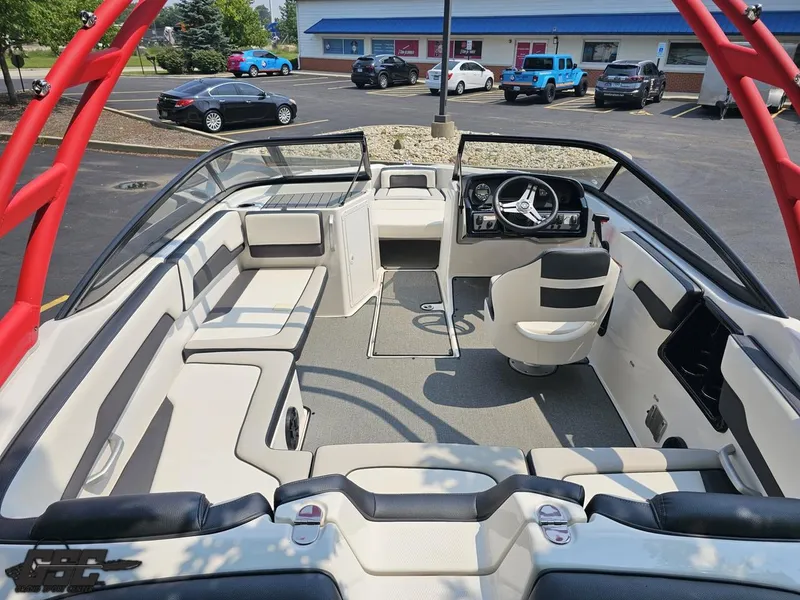 Slide: The Image of 2019 Yamaha Boats AR195 interior with seating and steering wheel, parked in a lot. - 38