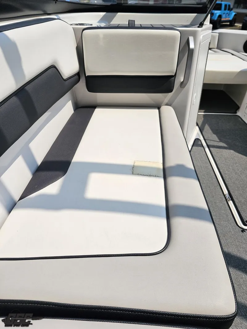 Slide: The Image of 2019 Yamaha Boats AR195 interior seating with white and black upholstery. - 47