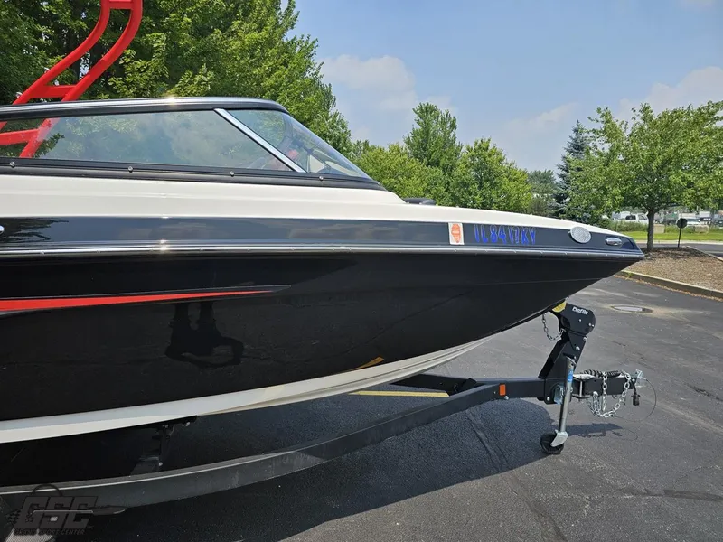 Slide: The Image of 2019 Yamaha AR195 boat on trailer, parked outdoors with trees in background. - 6