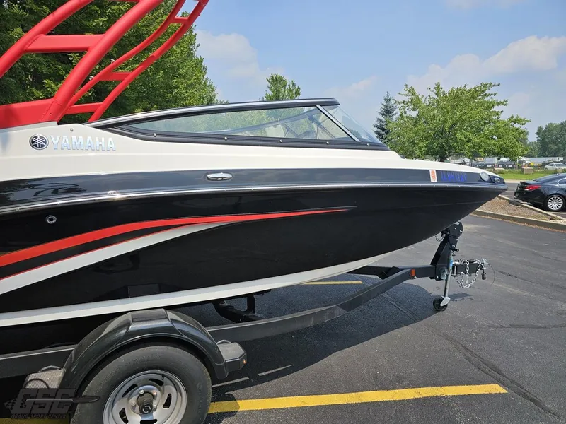 Slide: The Image of 2019 Yamaha AR195 boat on trailer, featuring sleek black and red design. - 7