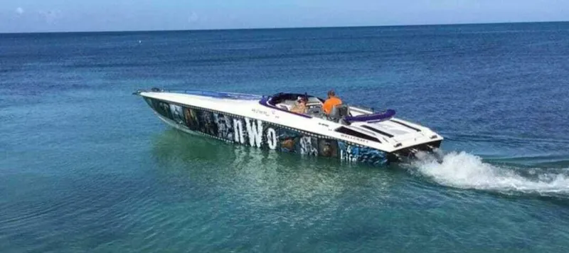 The Image of 1996 Wellcraft SCARAB speedboat cruising on clear blue ocean waters. - 1