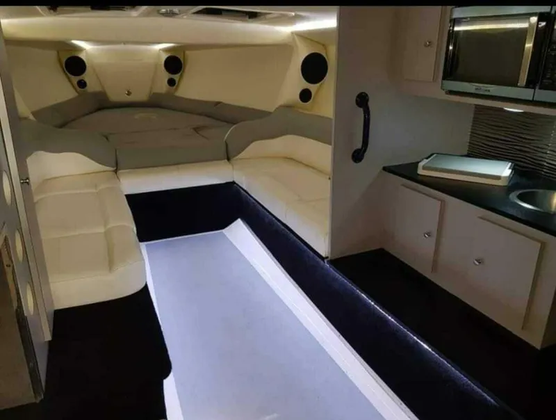 Slide: The Image of Interior of a 1996 Wellcraft SCARAB boat with seating, kitchenette, and modern amenities. - 13